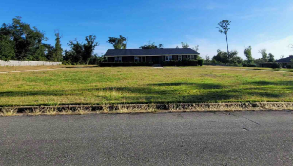 Picture of a house and the grass lawn. 